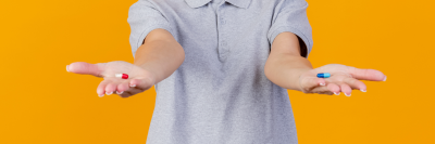 Woman holding out two tablets in her hands
