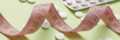 tablets on green table with measuring tape