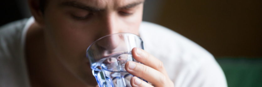 man sipping water