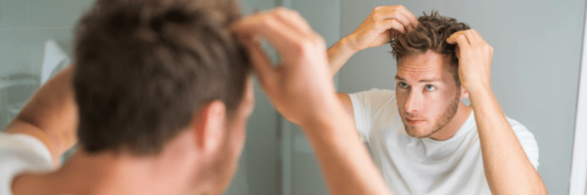 man checking for hair loss after steroids