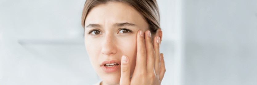 lady touching her eye