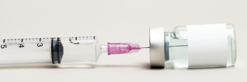 blank white labelled vial of medication with needle