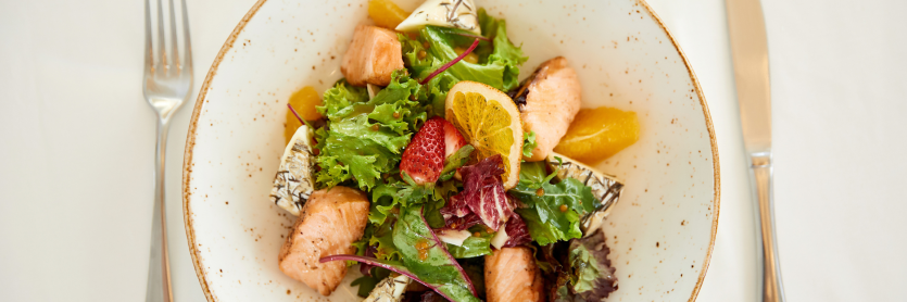 Plate of salmon, orange and cheese salad