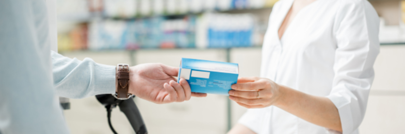 Man buying pills at pharmacy