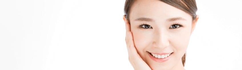 Smiling young woman holding the side of her face