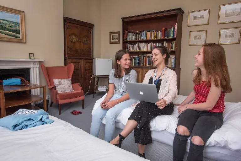 three-female-students-sat-in-dorm-room-studying-toogether