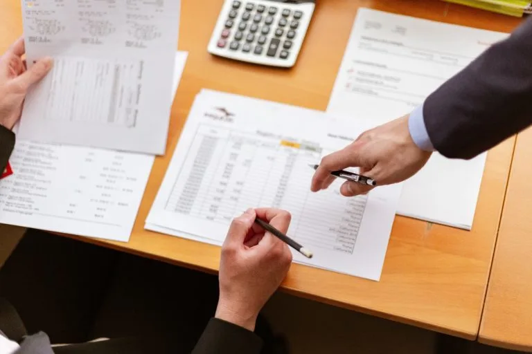 two-people-looking-at-finance-sheets