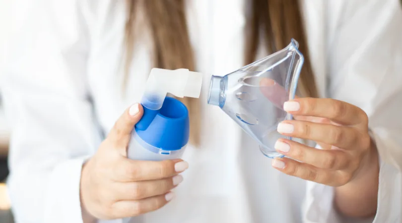 pharmacist-holding-nebulizer