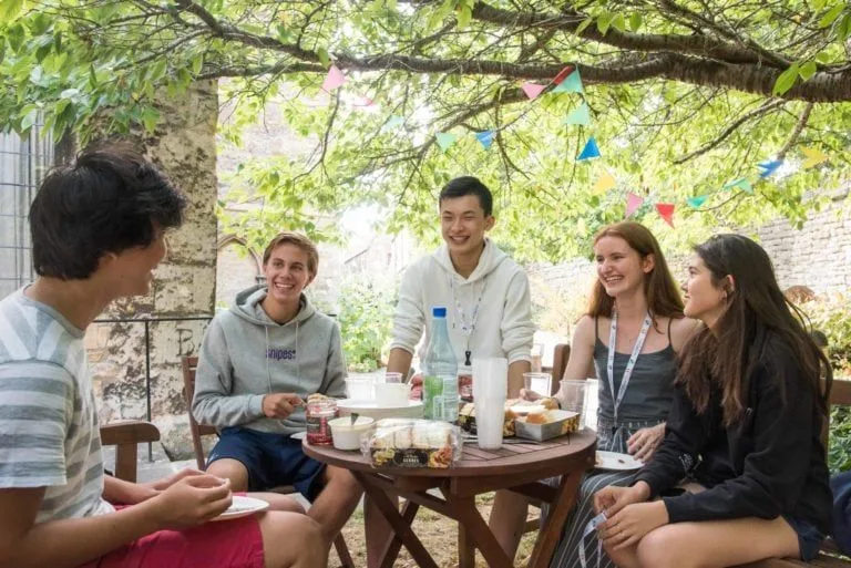 students-sat-outdoors-at-table