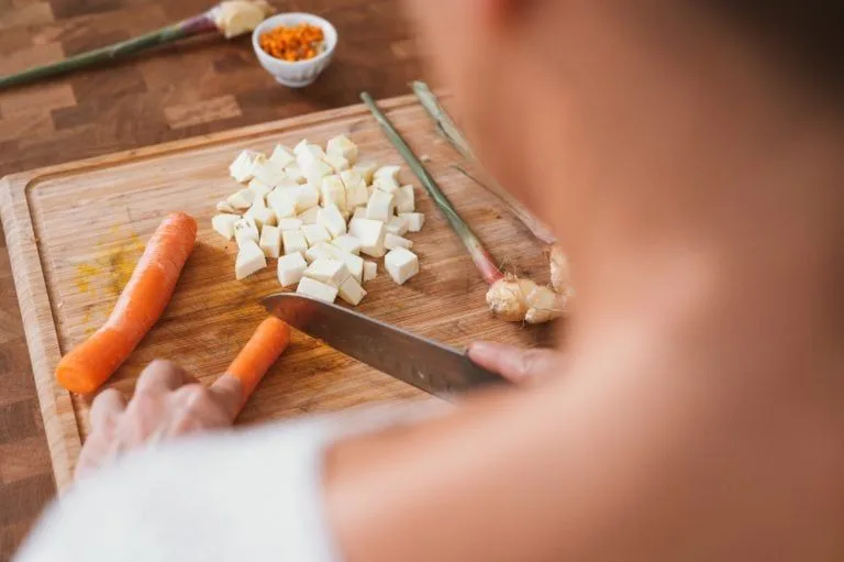 person-chopping-up-vegetables