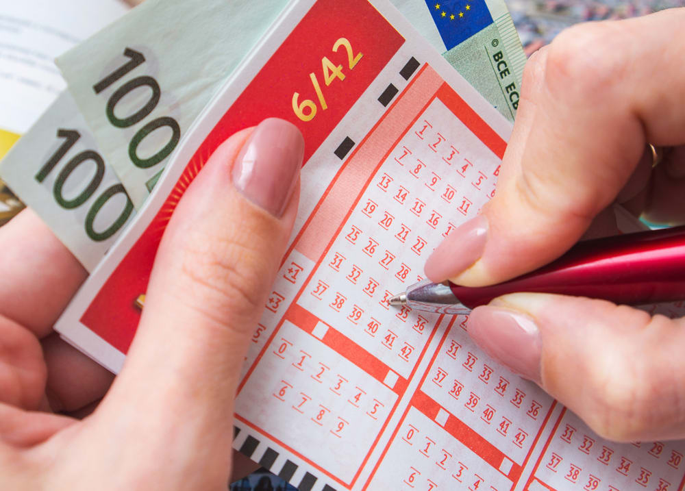 Filling,Out,A,Lottery,Ticket.,A,Young,Woman,Plays,The