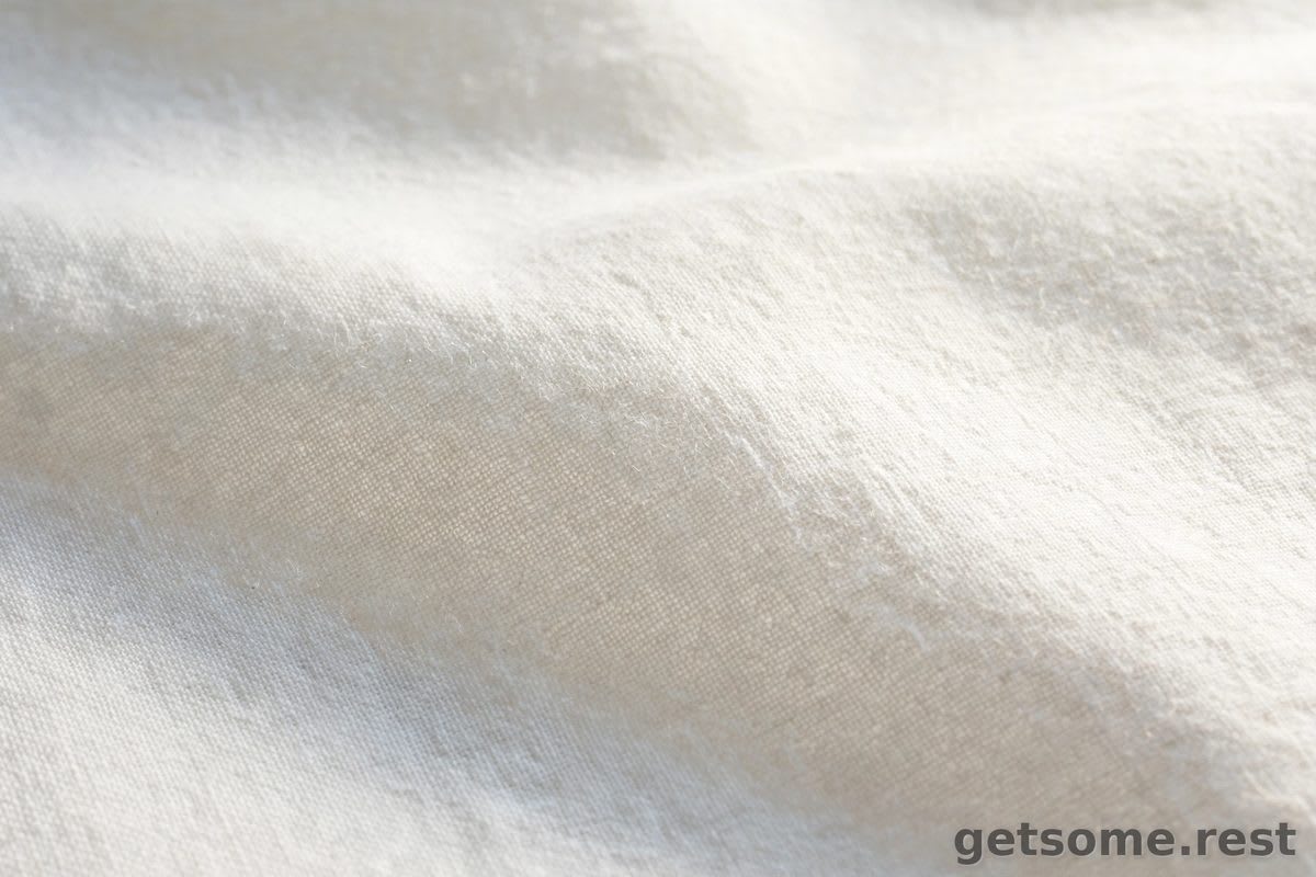 Macro close-up of fine percale cotton sheet weave fabric in soft white daylight