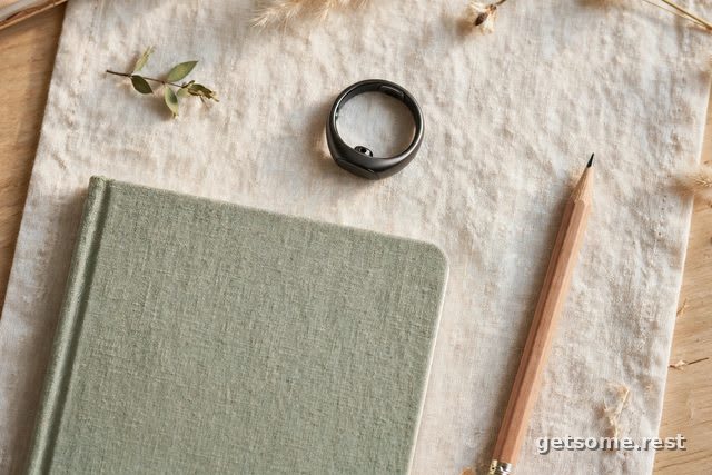 Oura Ring 4 smart ring in silver on a nightstand