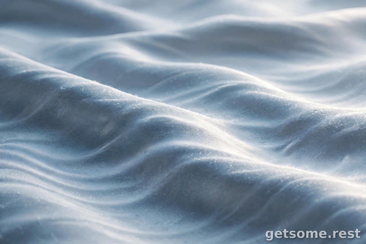 Extreme macro close-up of silky blue cooling fabric with a wave texture catching soft light