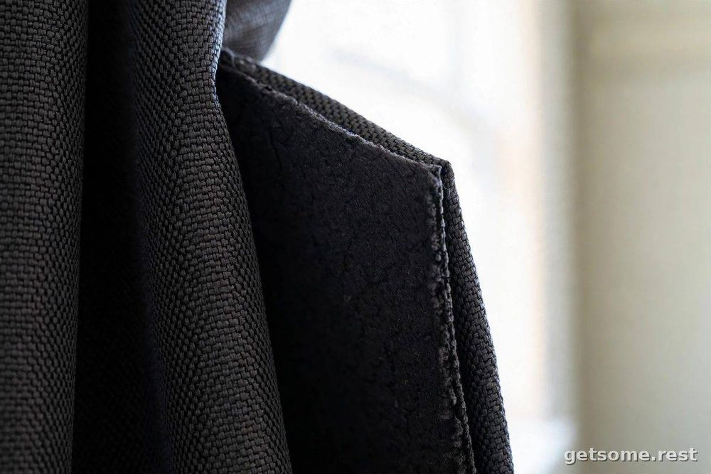 Close-up of dense triple-weave blackout curtain fabric blocking bright daylight
