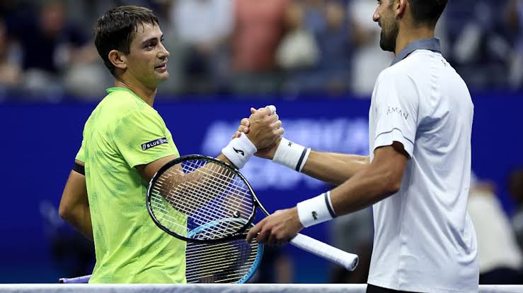 Navone and Djokovic shake hands after the monumental upset..