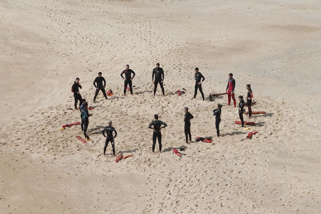 group-of-people-on-a-beach-having-a-surf-lesson