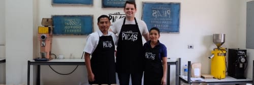 3 workers from Cafe Pacas standing together and smiling