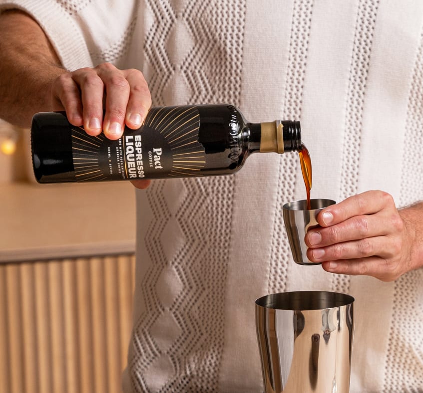 Pouring espresso liqueur for an espresso martini