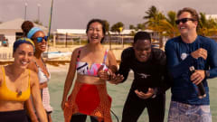 PADI dive crew laughing together on the beach during a tropical scuba outing