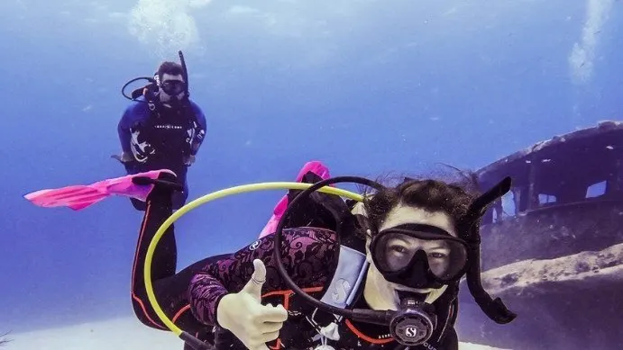divers underwater posing for the camera