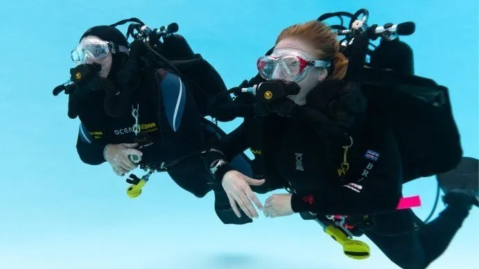 Divers with rebreathers in a pool