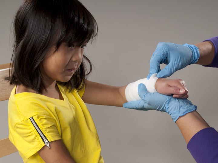 Bandaging childs hand