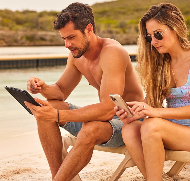 Man and woman sitting together using mobile devices