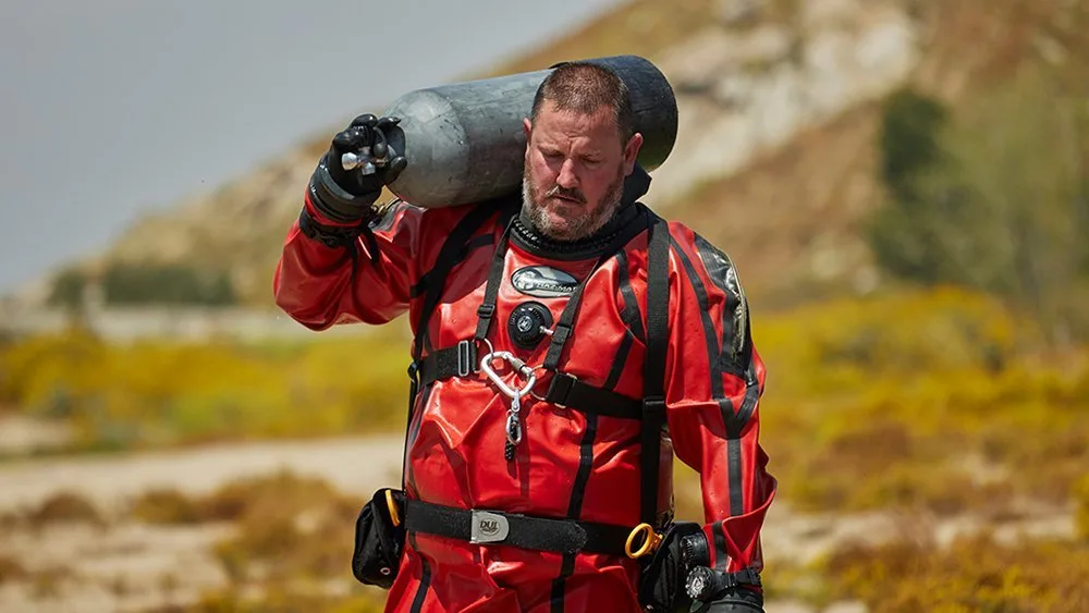 public safety diver carrying a tank