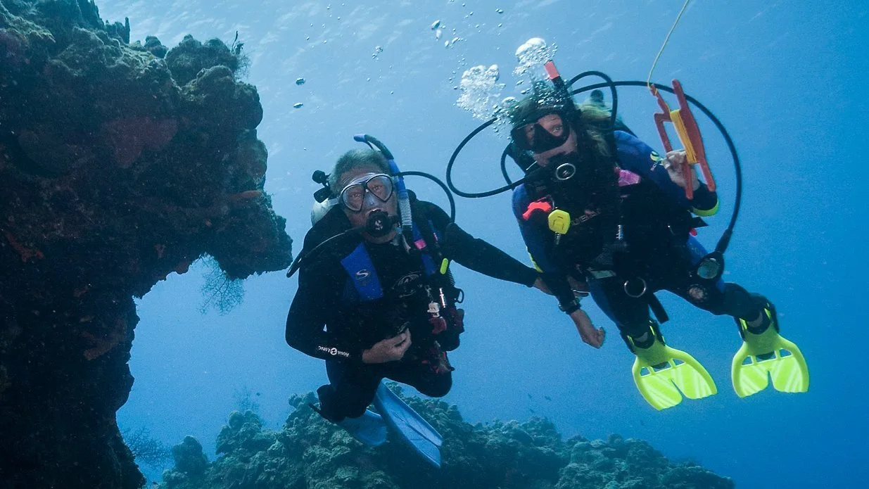 Two divers posing for a photo while drift diving.