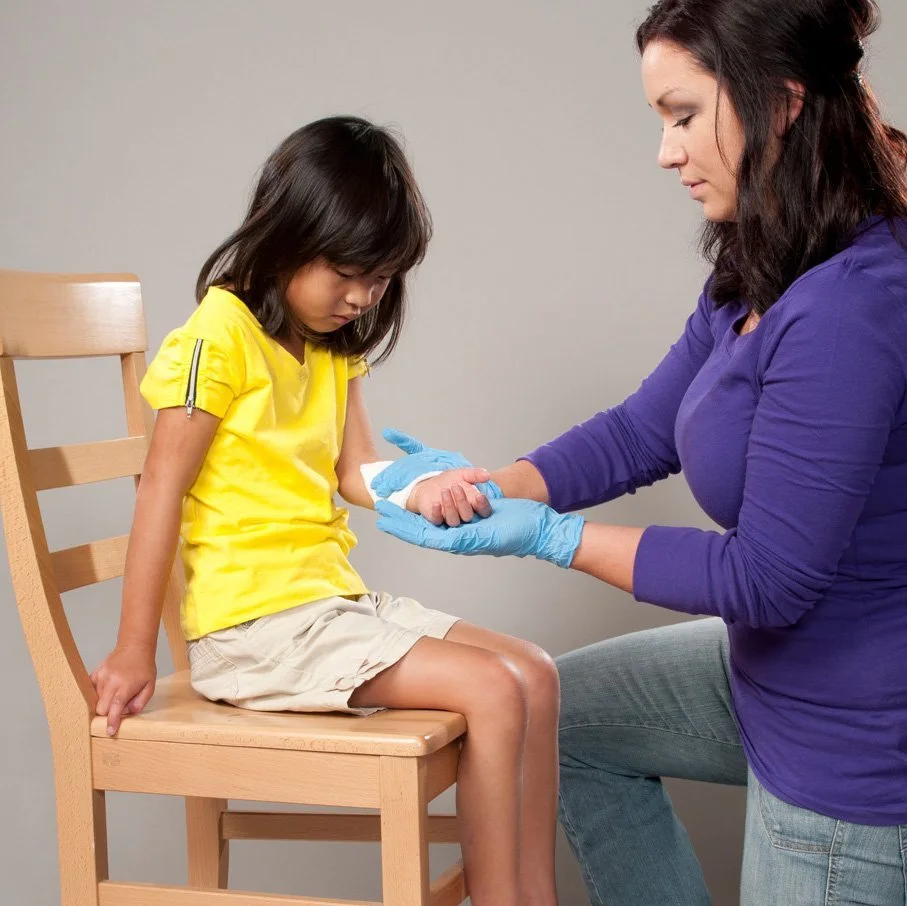 Woman providing first aid to a child