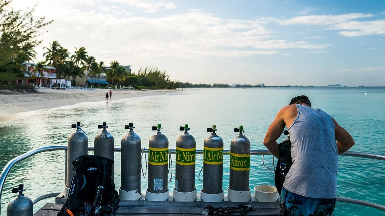 Diver checking tanks on a boat