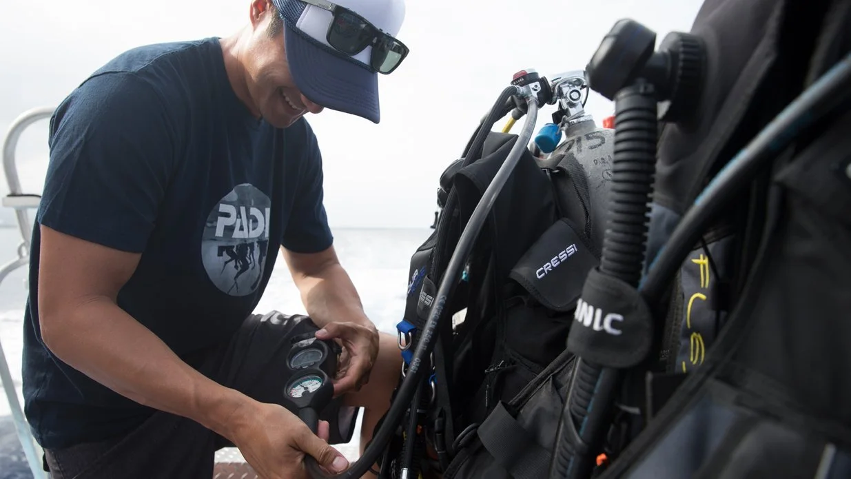 Diver checking pressure gauge
