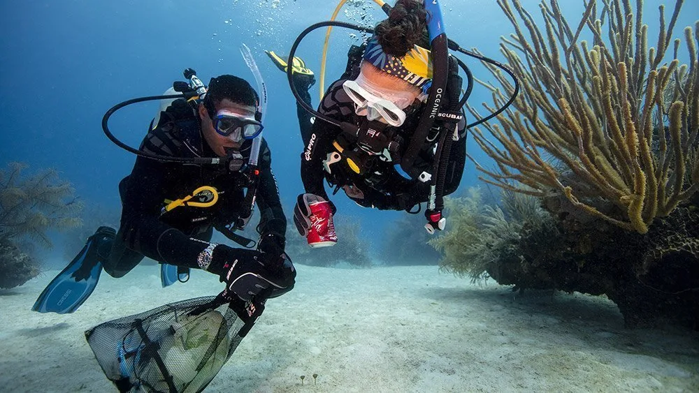 Two divers removing ocean debris