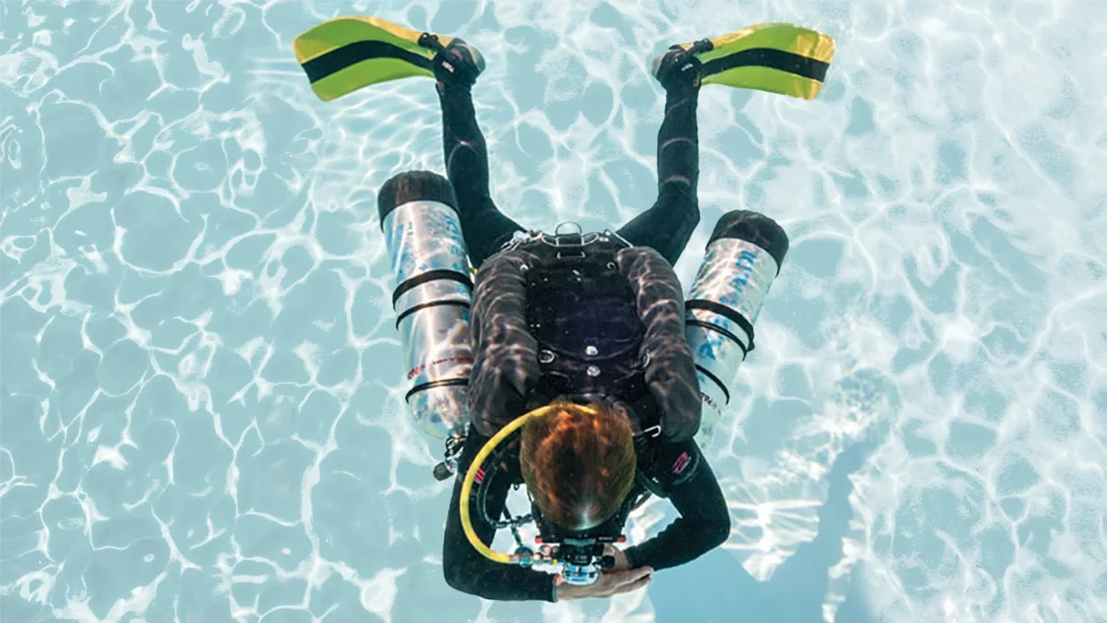 Diver practicing sidemout in a pool