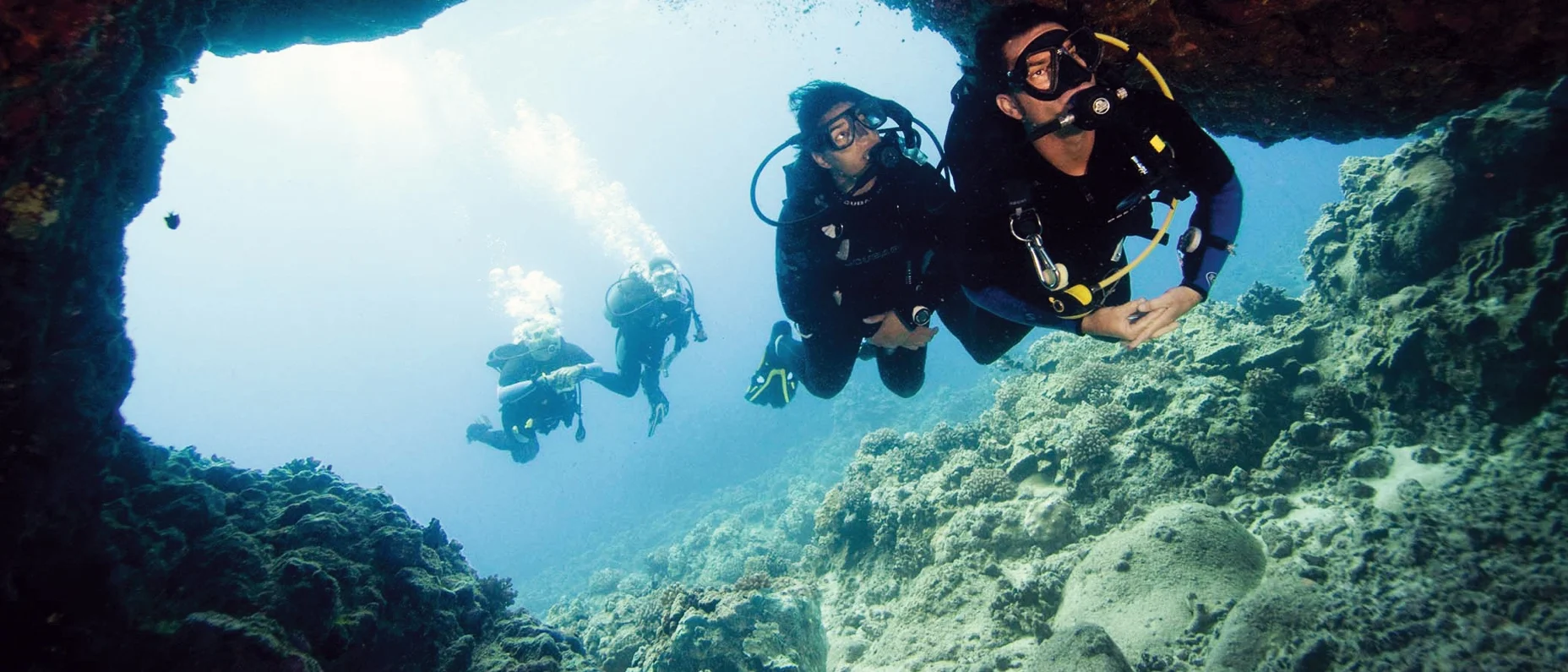 Divers going into a cavern