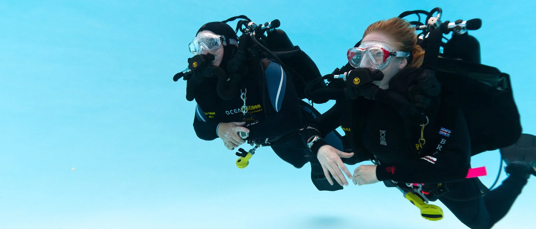 Divers with rebreathers in a pool