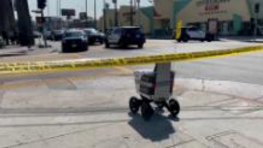 Watch: Delivery robot rolls through crime scene