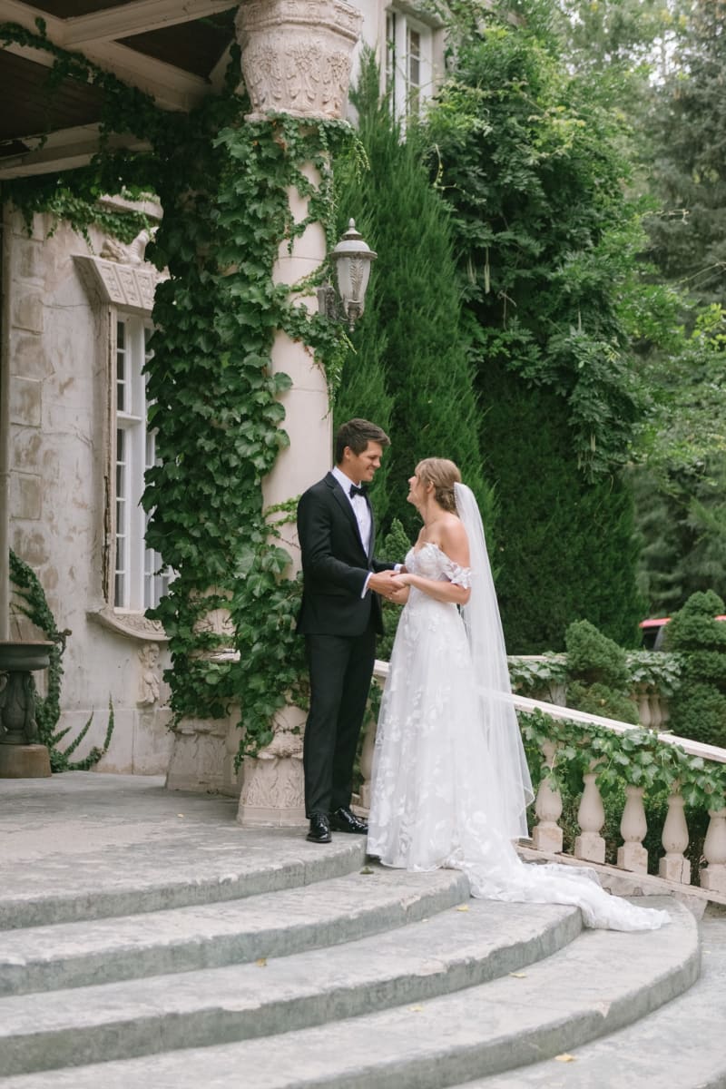 Bride and groom on the garden steps at La Caille in Sandy, Utah