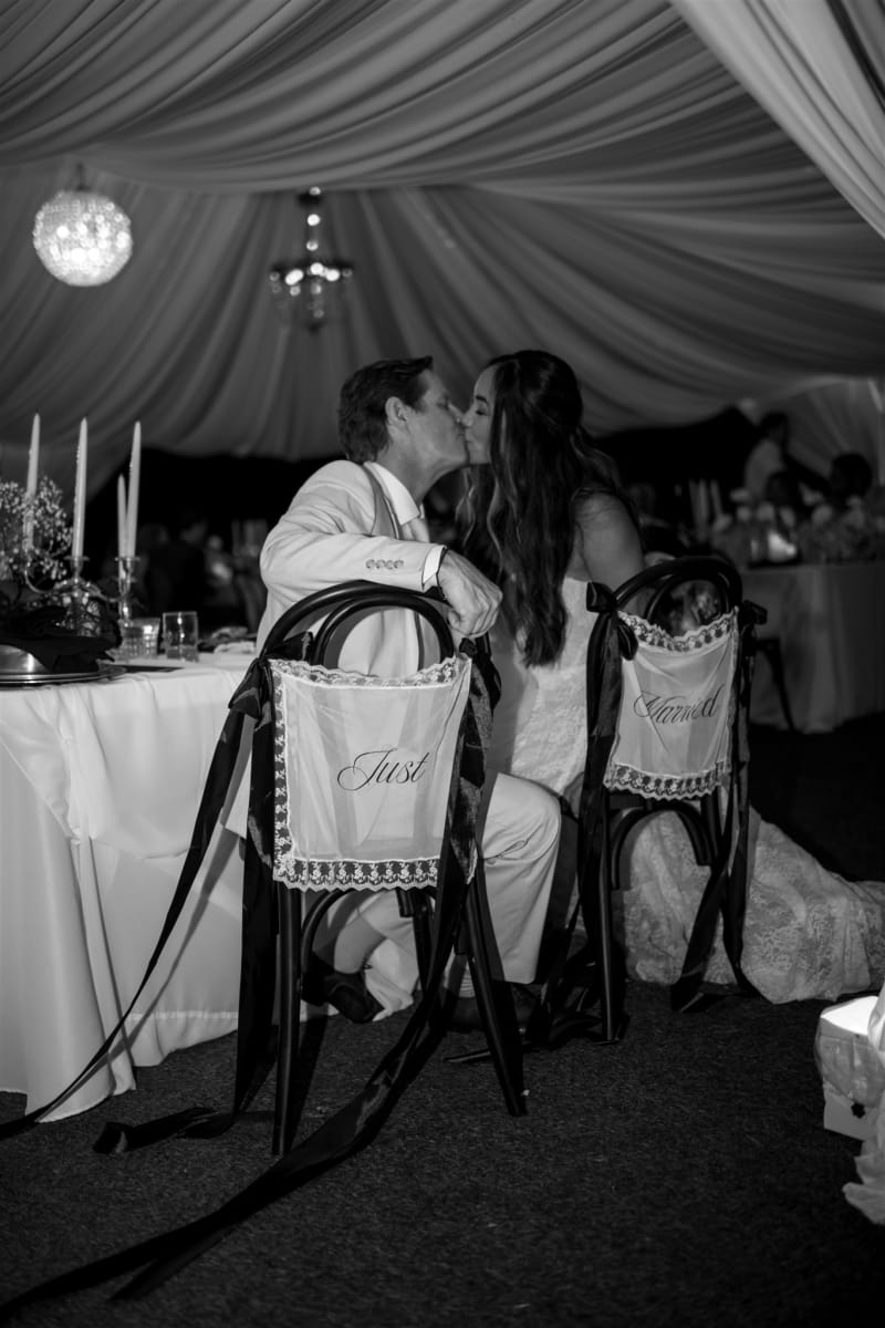 Black and white reception moment under the tent at La Caille in Sandy, Utah