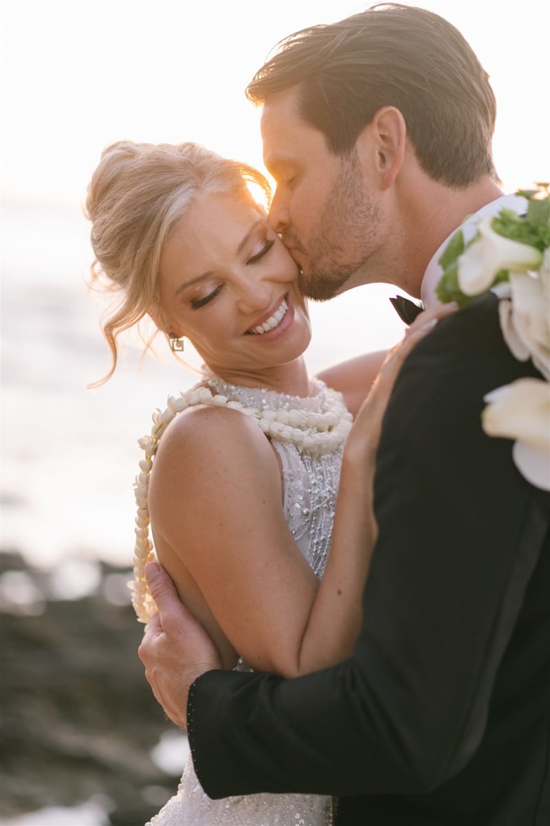 Bride and groom embracing at golden hour at Loulu Palms Farm Estate on Oahu