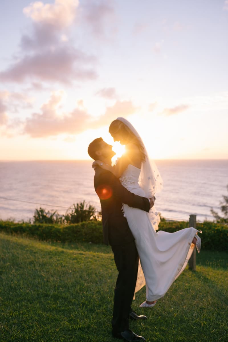 Bride and groom silhouetted at sunset at 1 Hotel Hanalei Bay Kauai