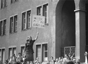 Nieder mit der Regierung - Down with the Government Documentary photo of girl holding sign in Leipzig, 17 June 1953