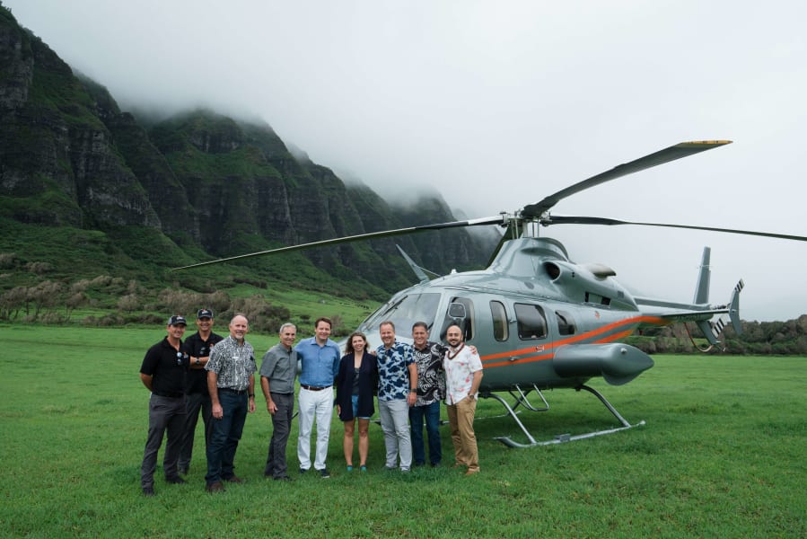 Group photo in front of helicopter 