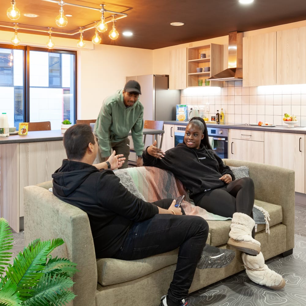 Students socialising around a sofa