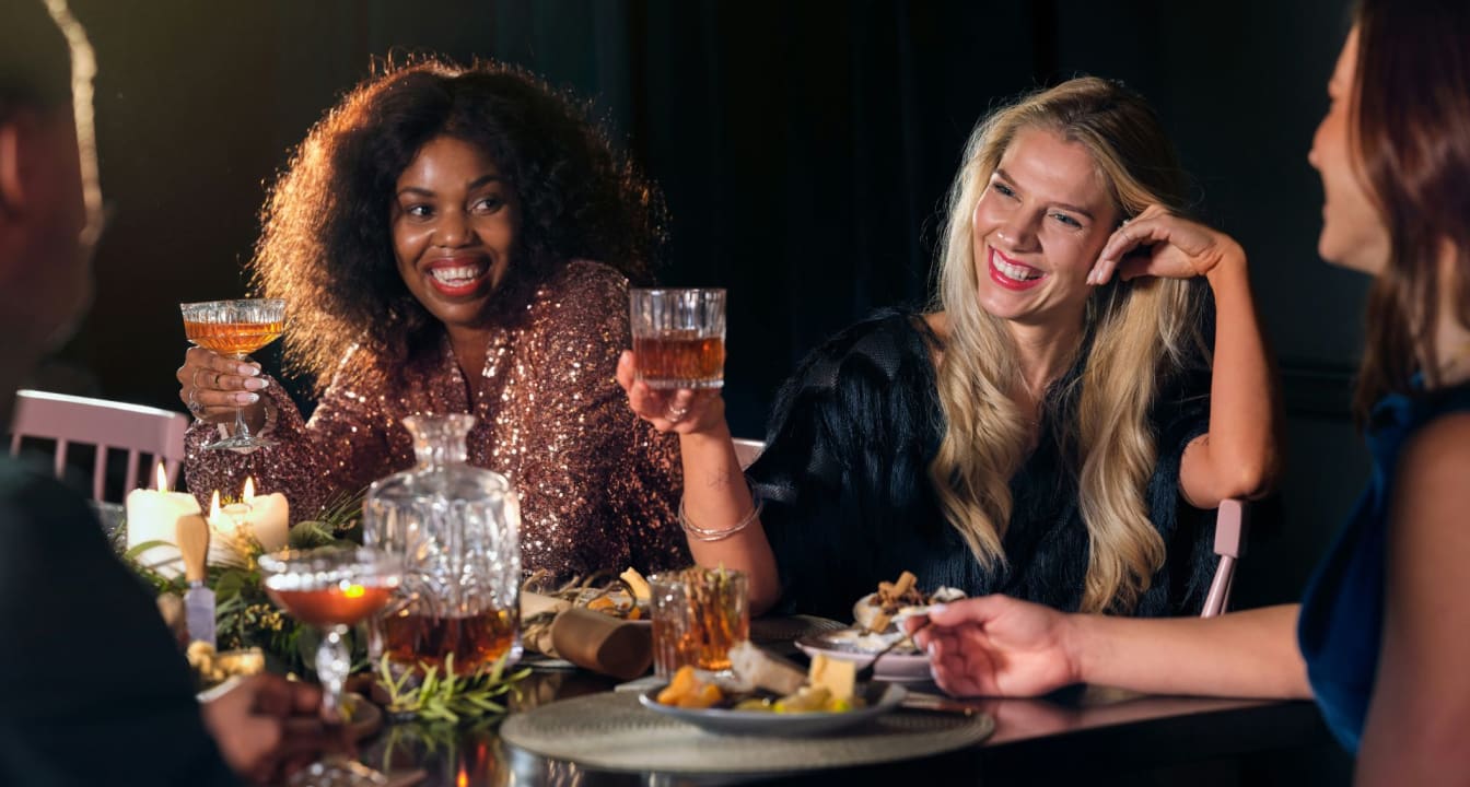 Four friends eat Christmas dinner with whisky