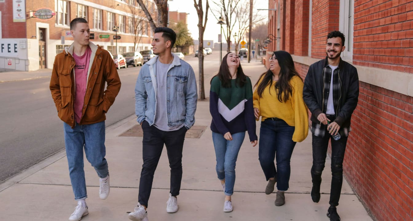 Five students walking down the street