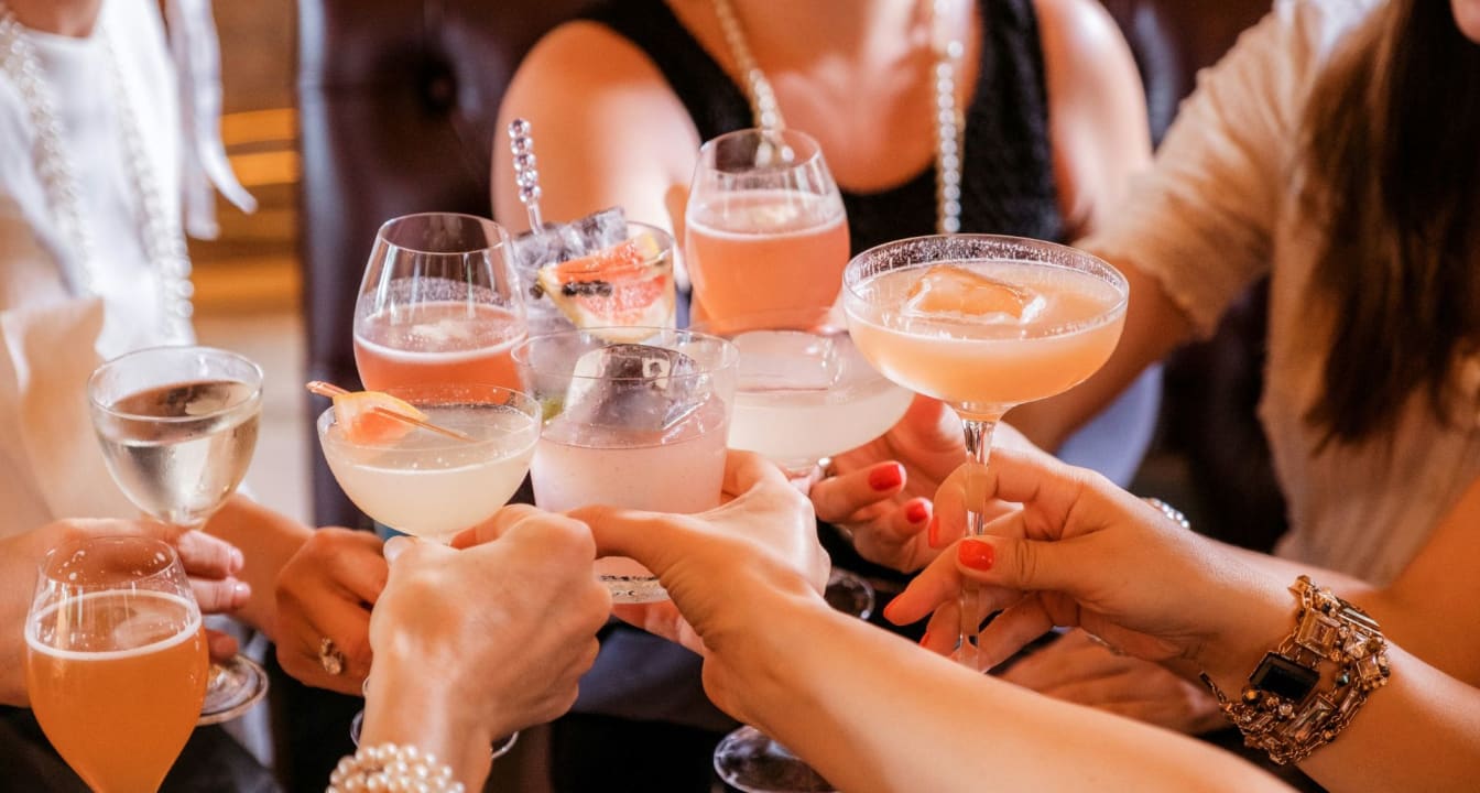 Pink Cocktails Being Clinked Together