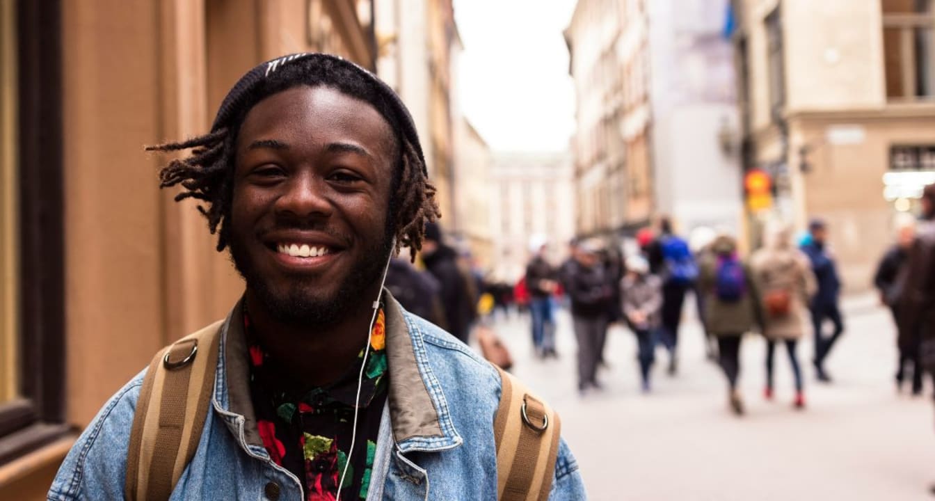 Close up of male student smiling in the street