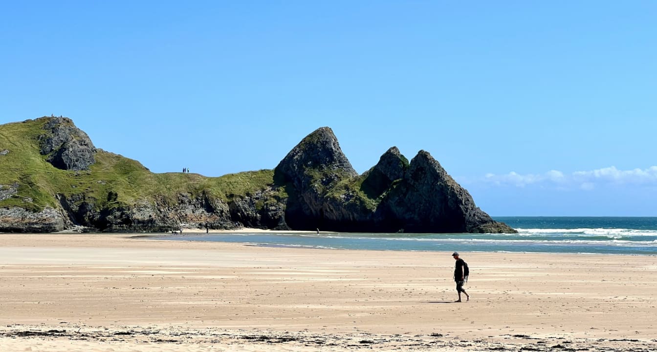 Man walking on the beach in Swansea